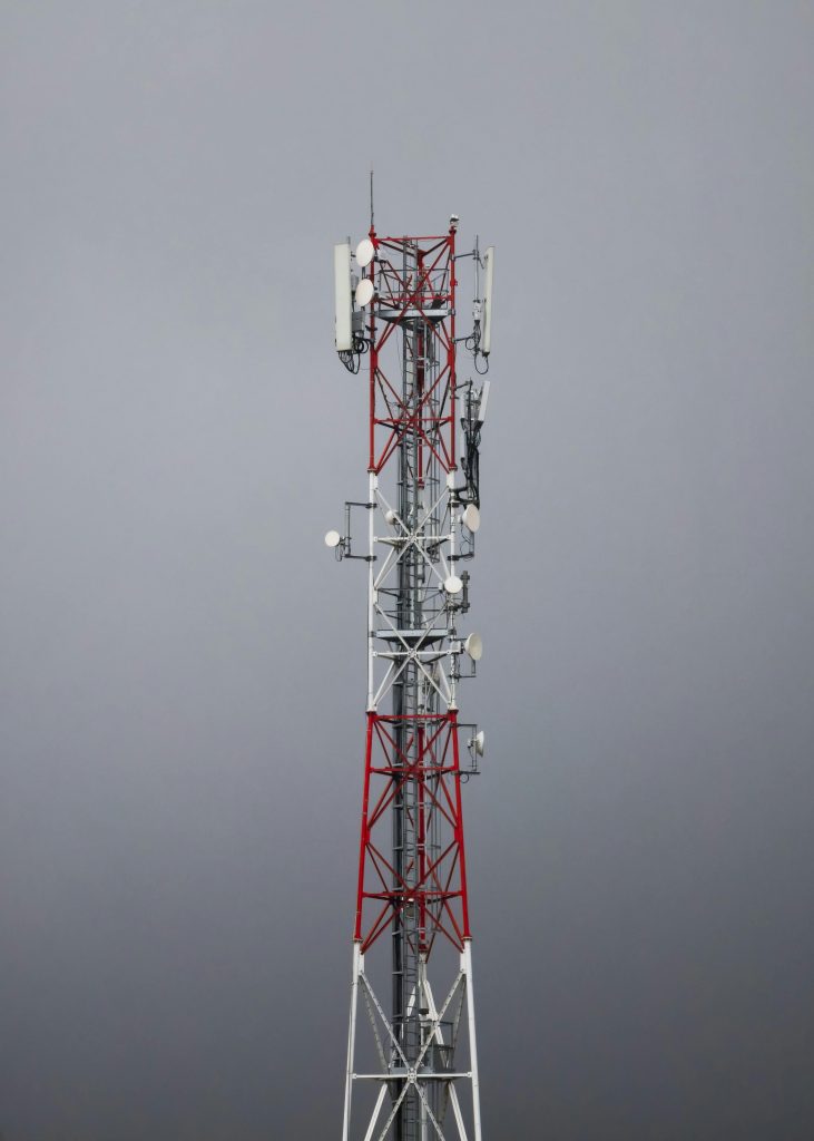 A tall communication tower with antennas against an overcast sky, symbolizing modern connectivity.
